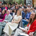 Does “Our Amsterdam” policy include internationals and startups?